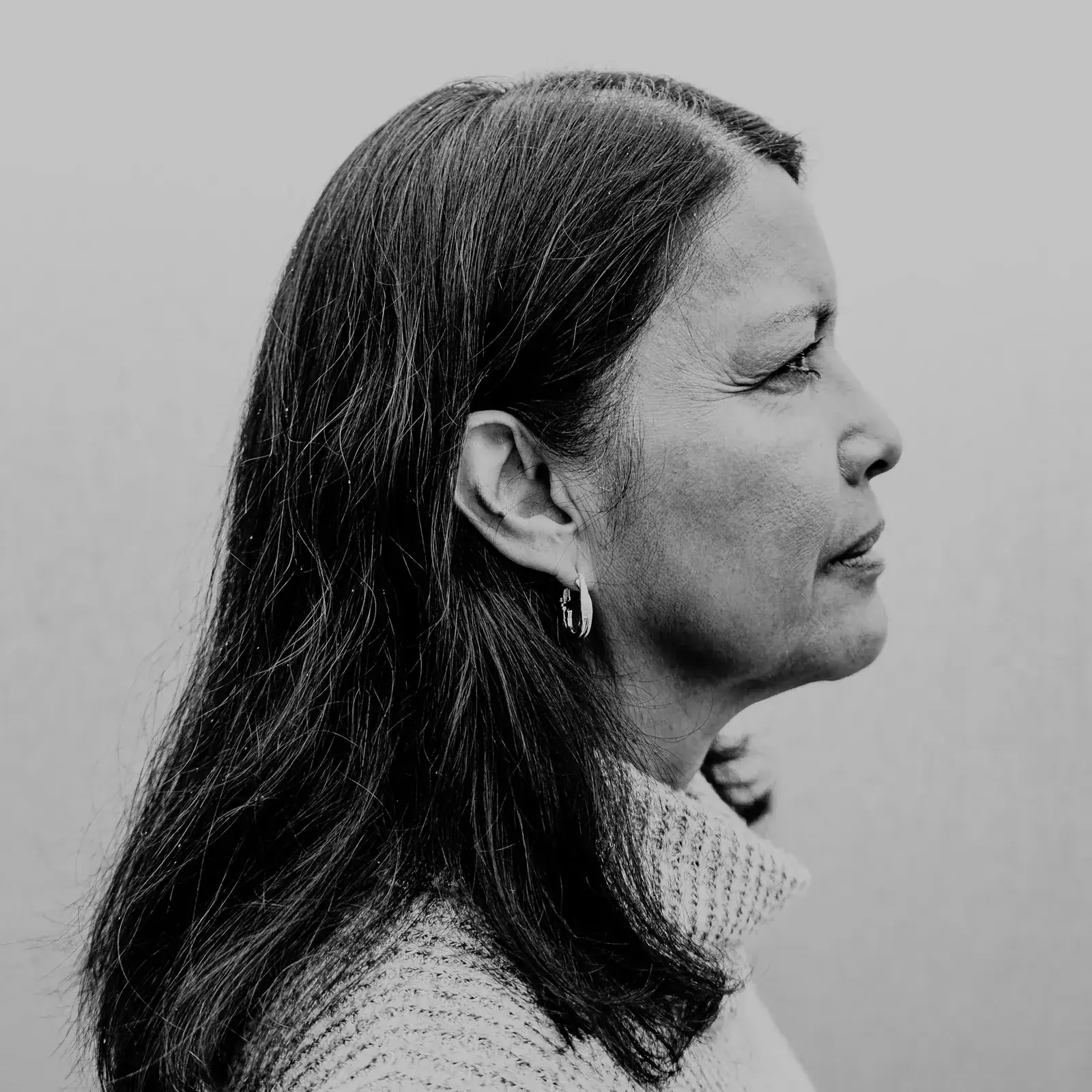 A black and white portrait in profile, the line of the jaw clearly visible